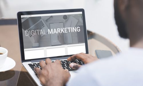Digital Marketing. Unrecognizable African Man Working On Laptop Promoting His Online Business Sitting In Cafe Outdoors. E-Commerce And Web Content Promotion. Panorama, Collage With Text
